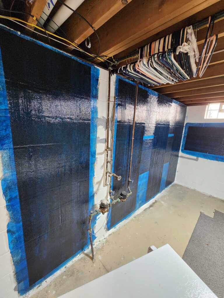 Basement waterproofing wall treatment applied to concrete foundation walls to help prevent moisture damage and structural issues