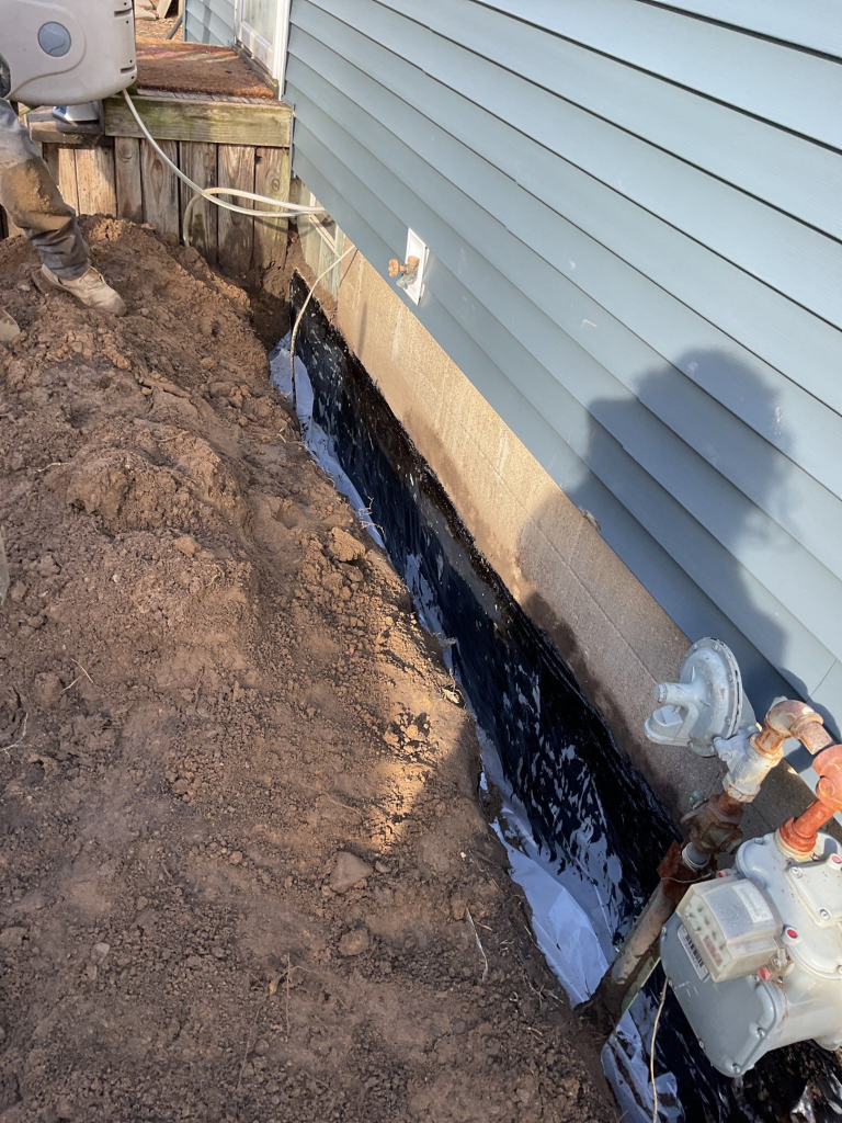 Exterior basement waterproofing with drainage system and foundation membrane installation